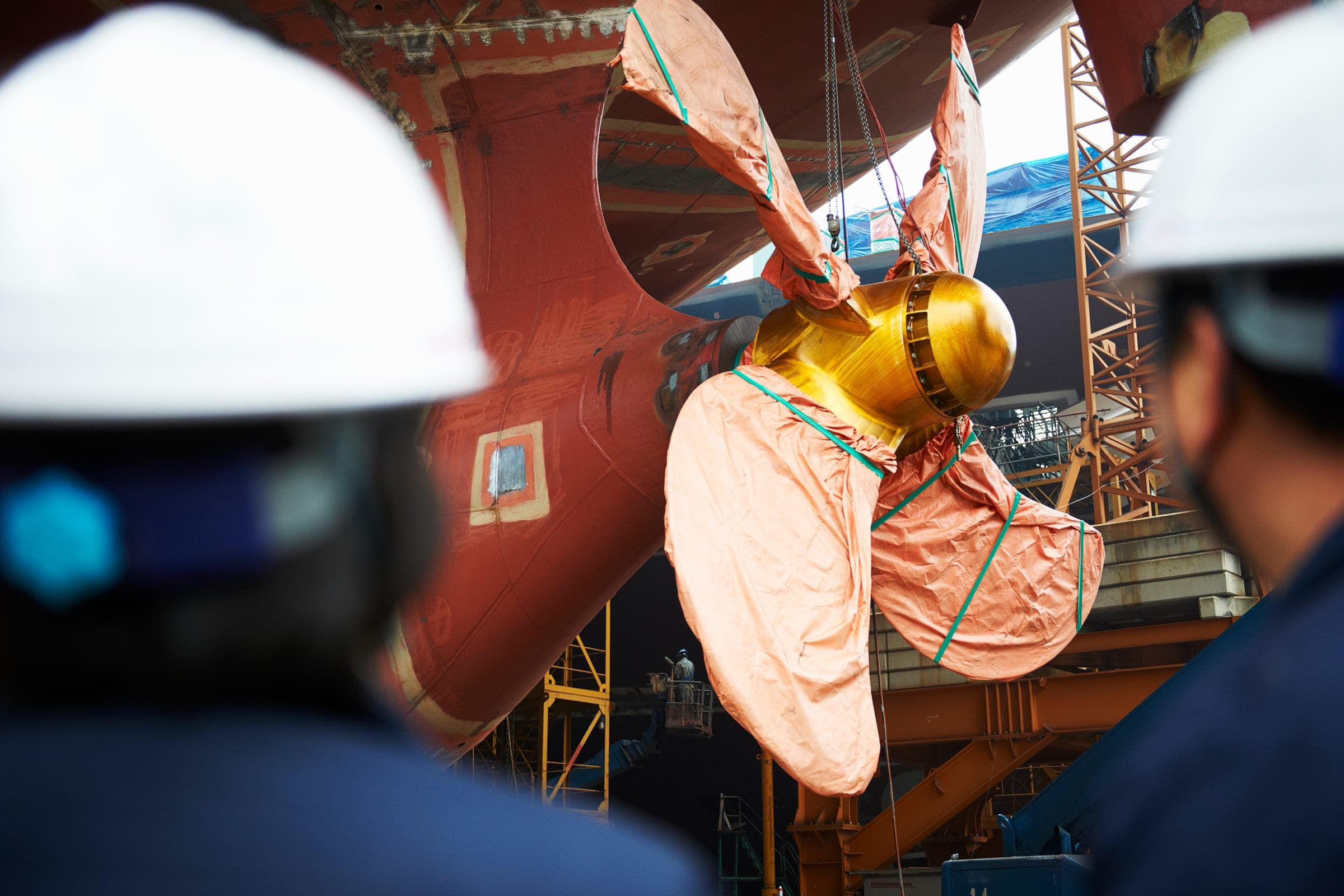 Propeller being fitted to a hull under survey