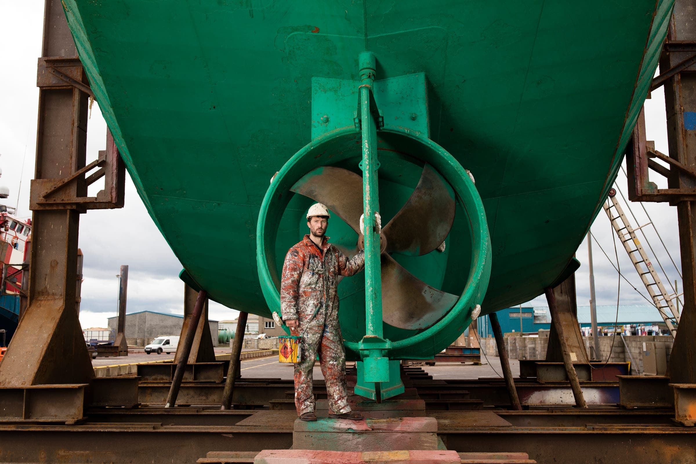 Worker beside a vessel propeller in dry dock